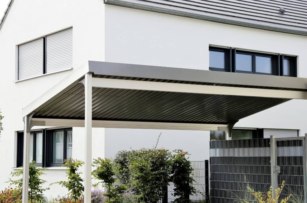 Timber carport attached to the side of a home, providing covered vehicle parking