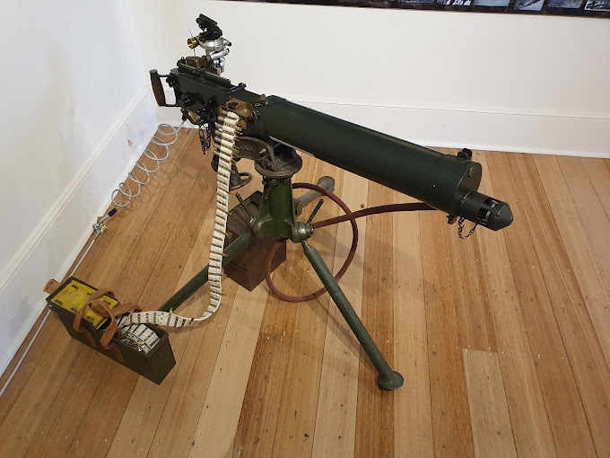Vickers machine gun displayed on a timber floor inside the Army Museum of Tasmania
