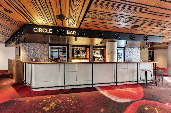 Circle Bar inside Theatre Royal, Hobart, with a curved wooden-panelled ceiling and red patterned carpet