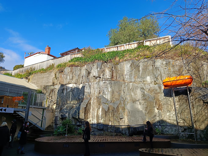 Sandstone quarry-face courtyard at Salamanca Arts Centre with an amphitheatre-style seating deck